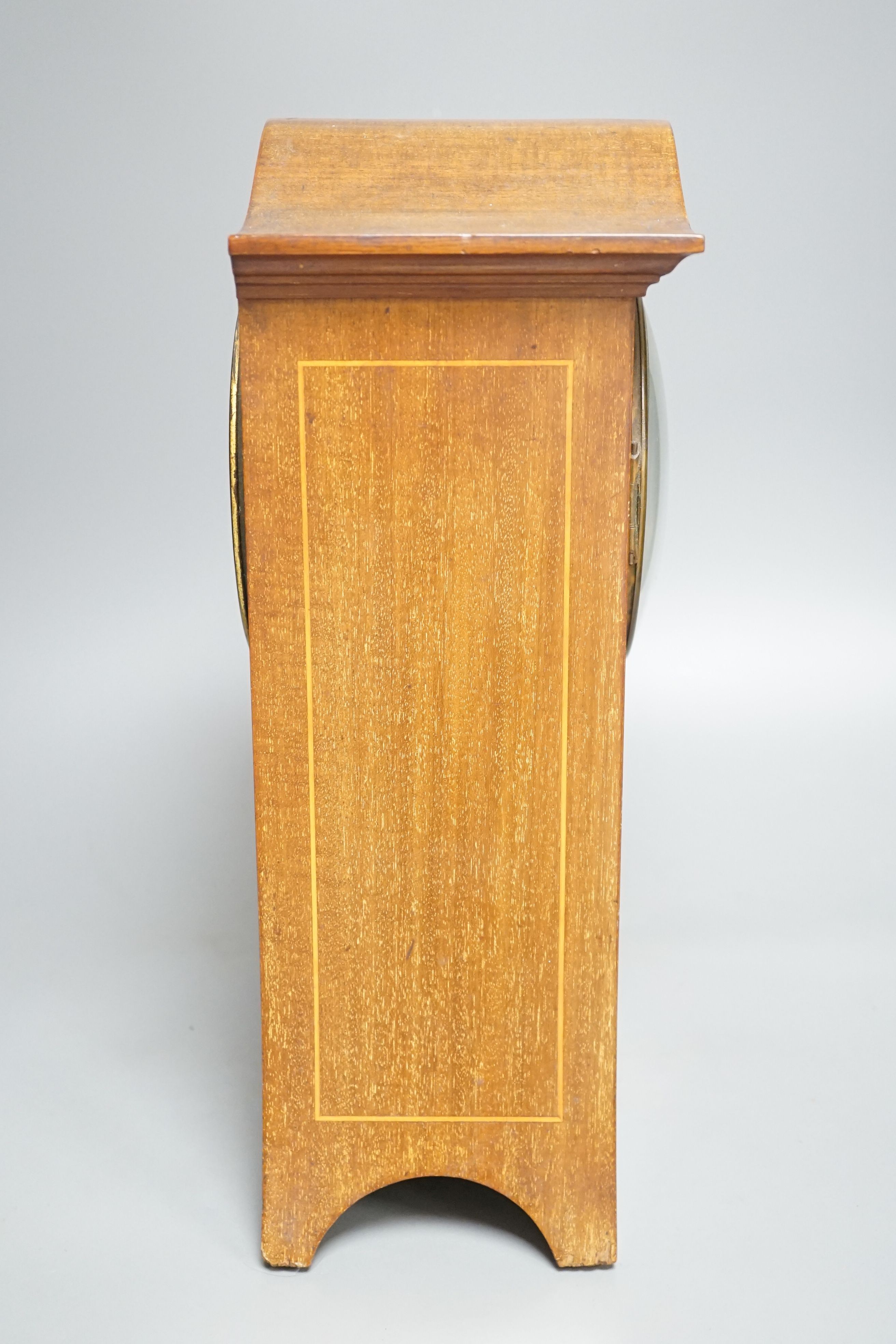 An Edwardian inlaid mahogany mantel clock with French gong-striking movement, 39cm.